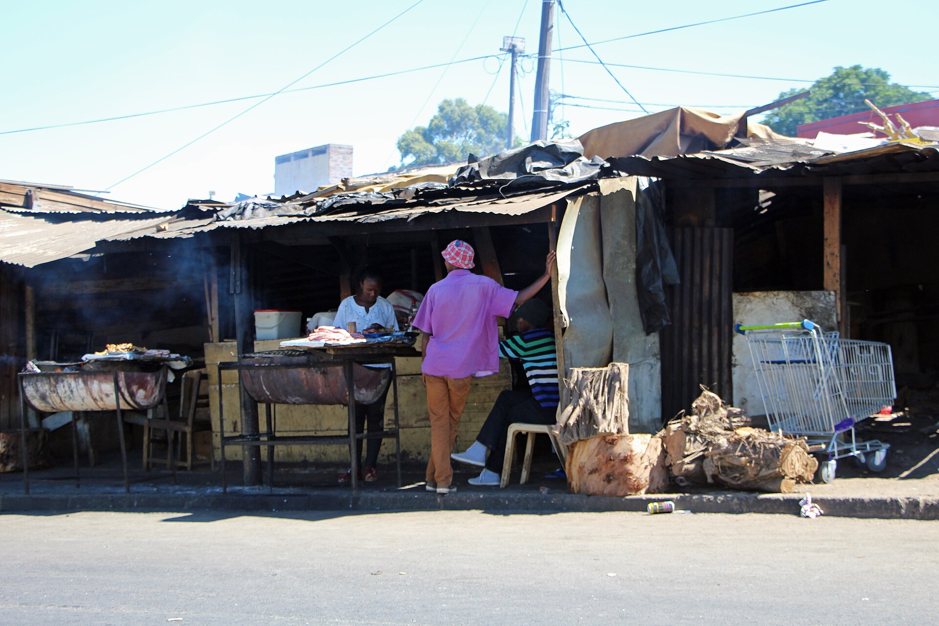 Meat on tables at a pavement braai stand near the entrance to Kayamandi, Stellenbosch.
